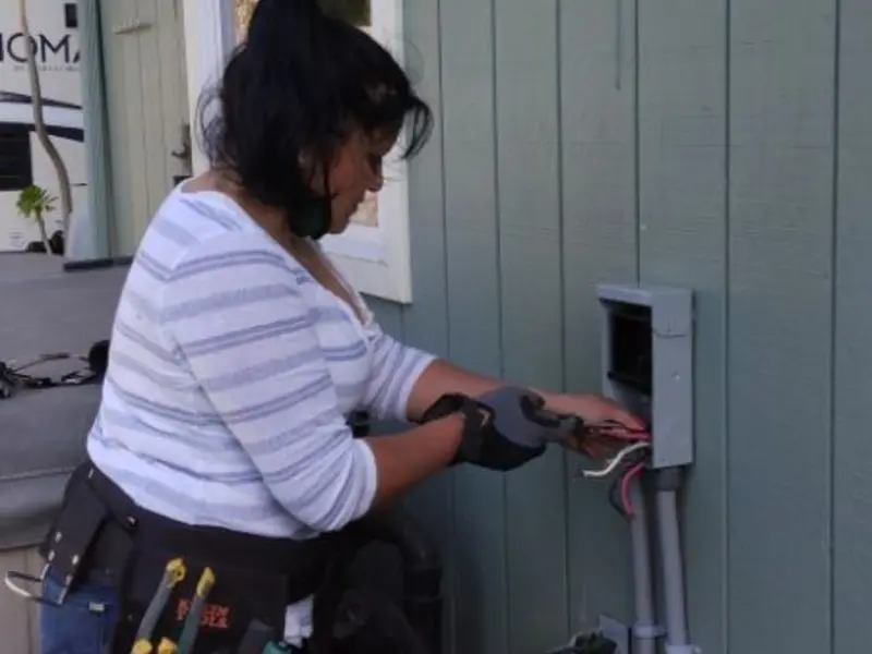 Licensed electrician wiring an exterior subpanel in Braddock