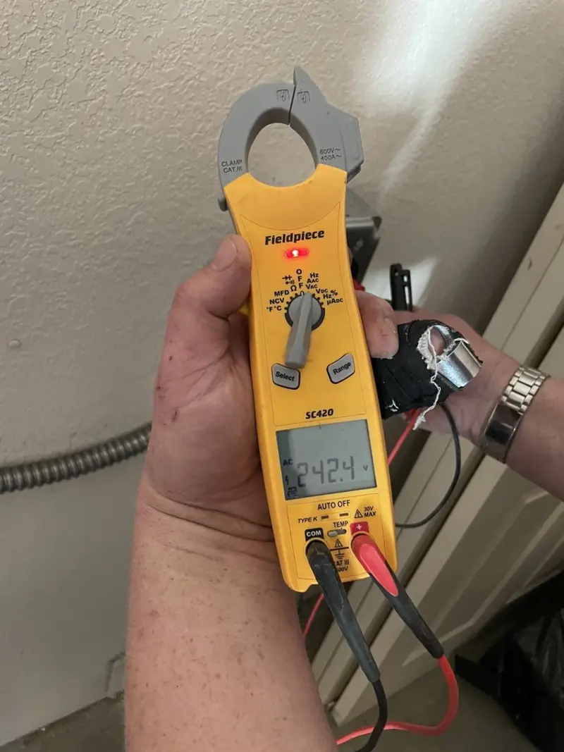 Voltage testing with clamp meter during Recessed Lighting Installation in Braddock